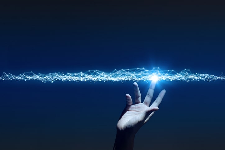digital power waves being touched by human hand